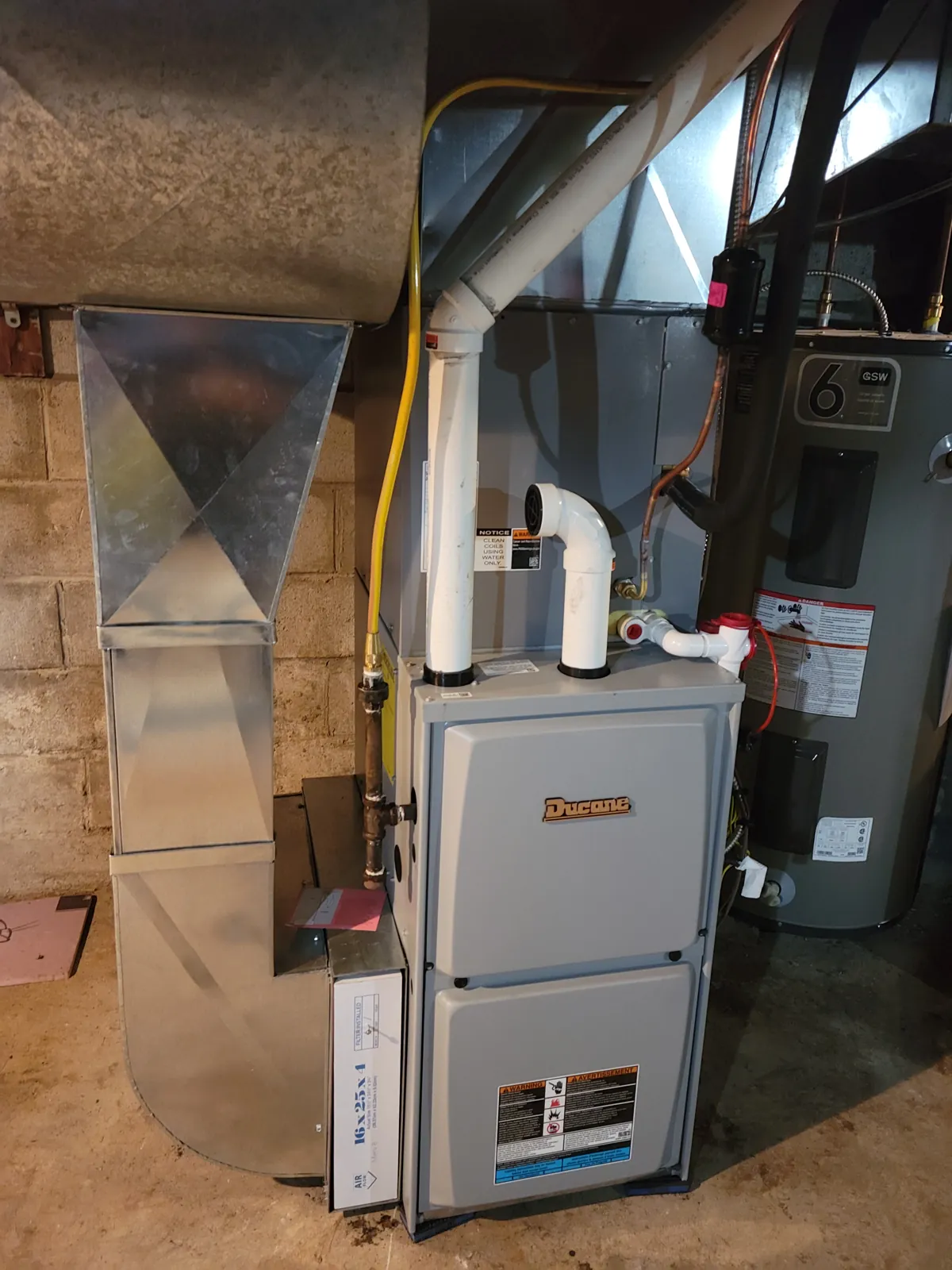 New Ducane high efficiency furnace with custom galvanized ductwork in a basement