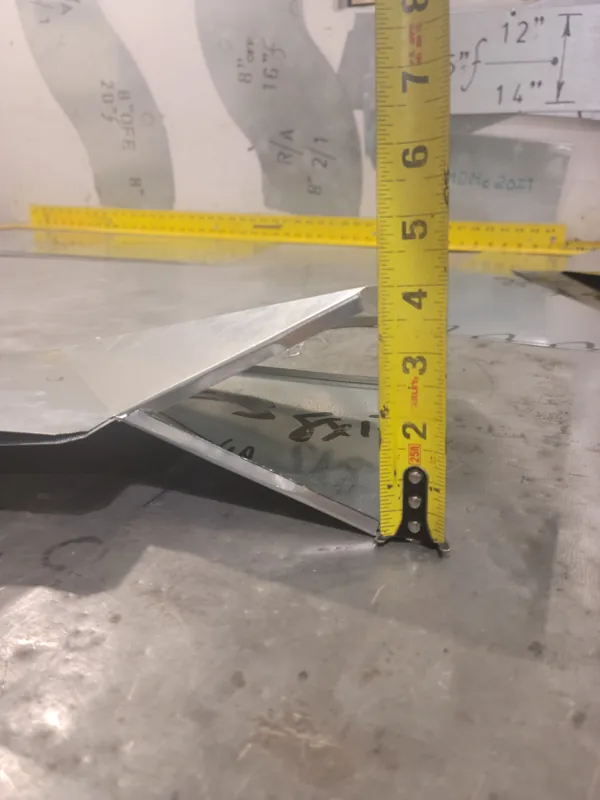 Tape measure checking a bent galvanized piece