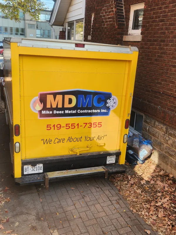 Back of the yellow MDMC truck with the phone number