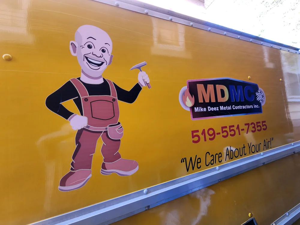 Side of the yellow MDMC truck with the company mascot and logo