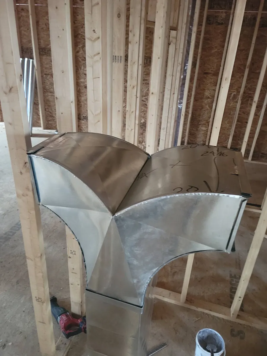 Custom galvanized wye fitting in new construction framing