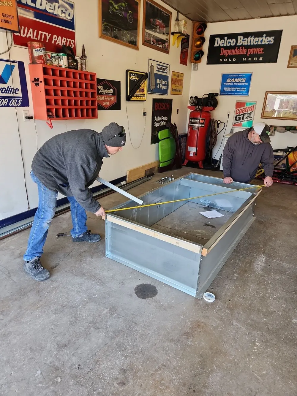The MDMC crew measuring a large galvanized plenum in the shop