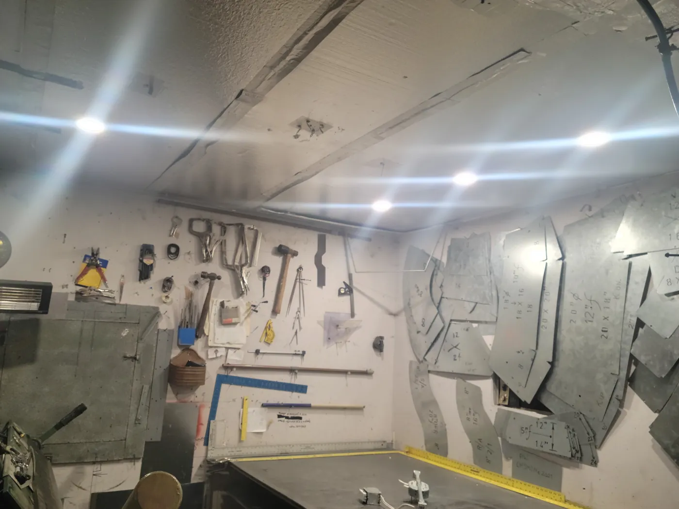 Inside the MDMC truck shop, with hand tools and sheet metal patterns on the walls